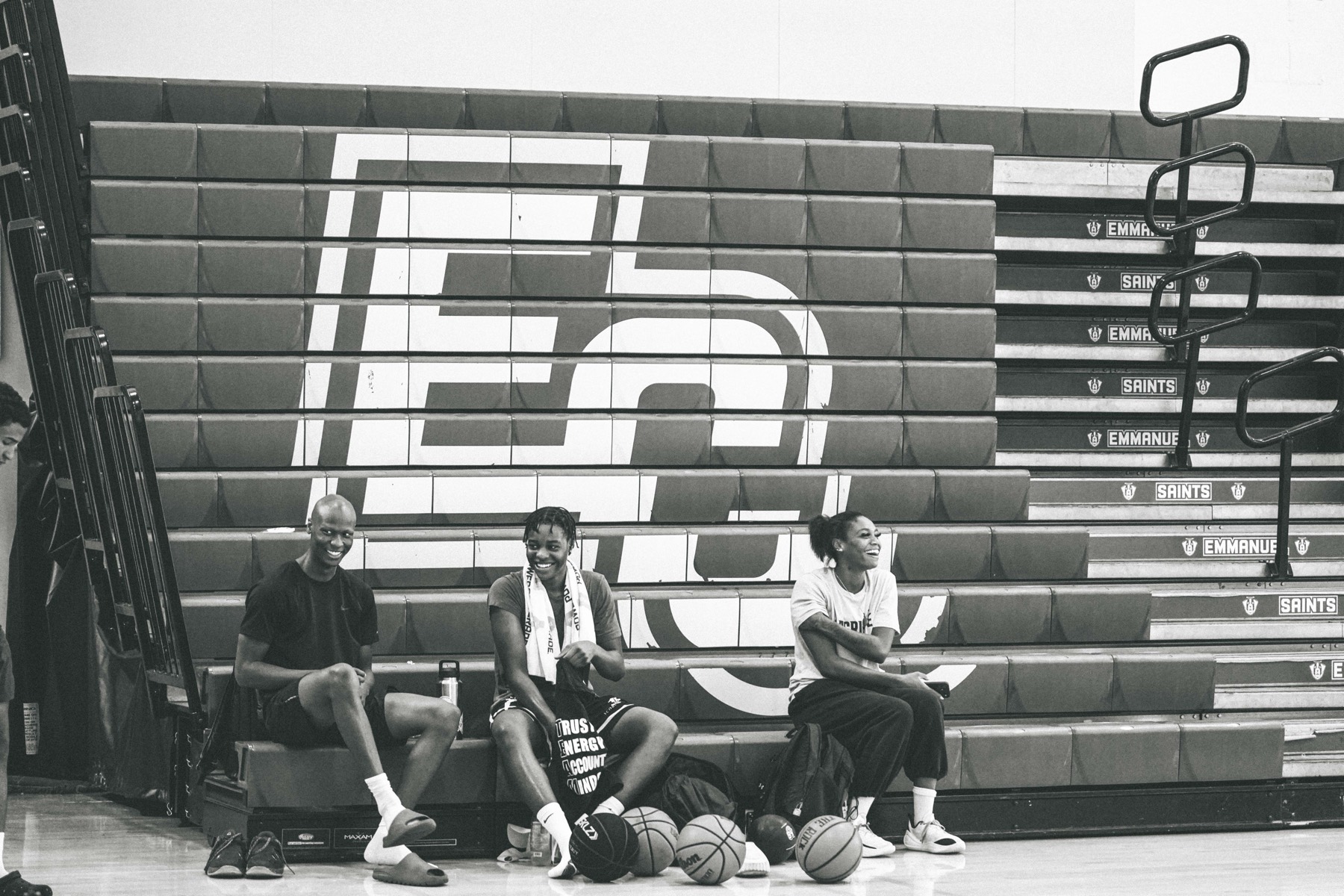 Three players sitting together on the bleachers after practice